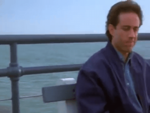 Jerry Seinfeld thinking deeply on a pier.